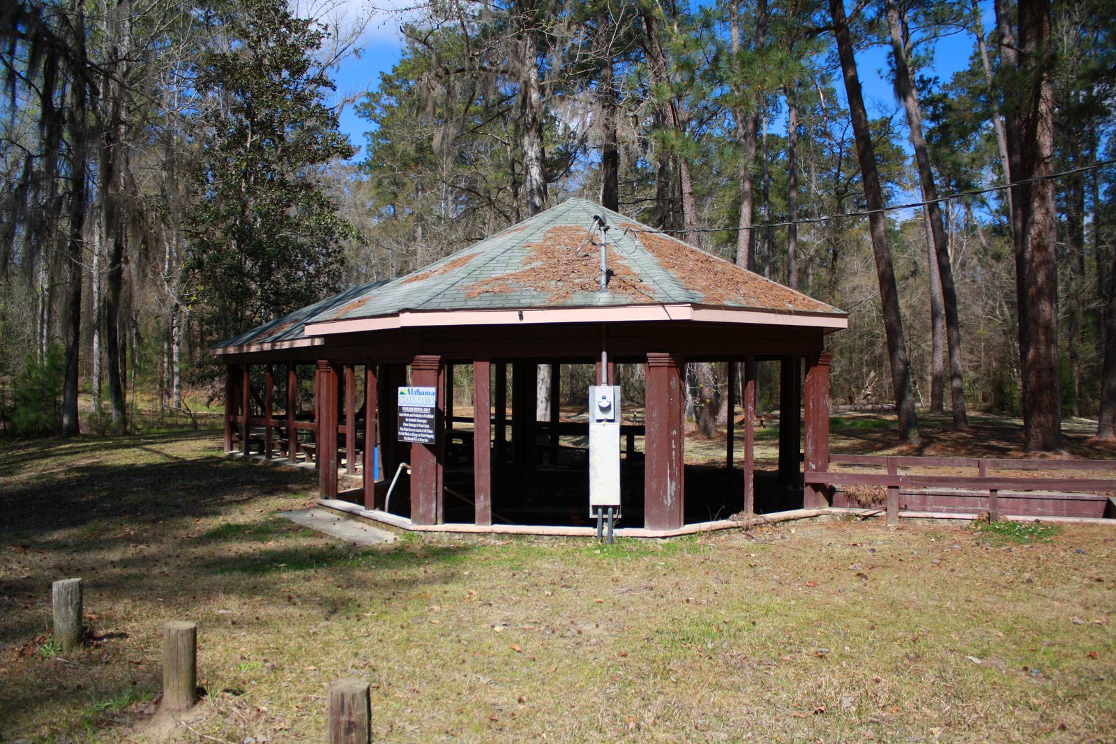 Wooden spring pavilion among trees at Bladon Springs State Park, Alabama