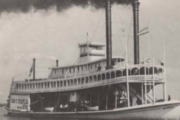Black-and-white photograph of the sternwheel steamboat James T. Staples with twin smokestacks billowing smoke