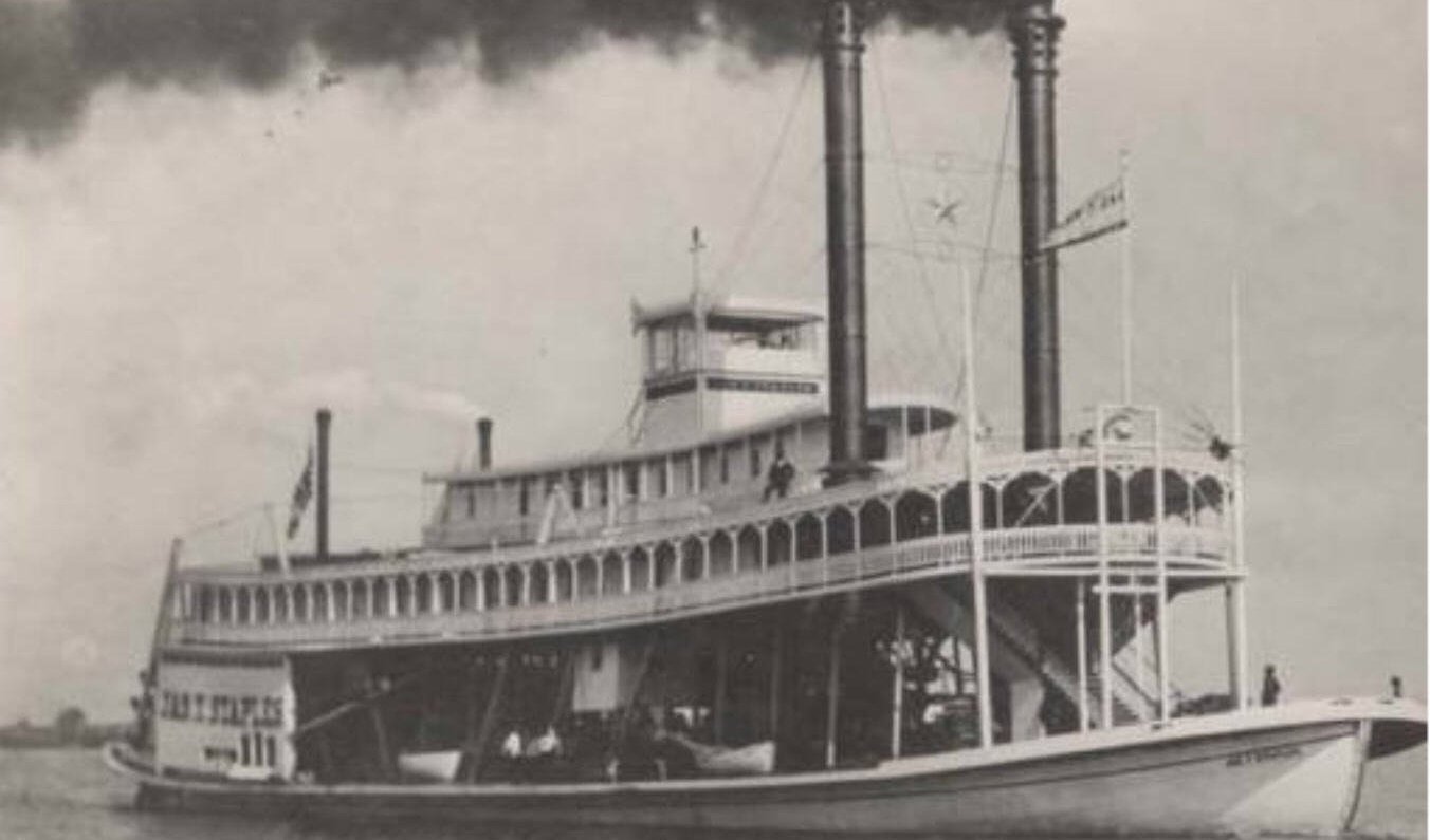 Black-and-white photograph of the sternwheel steamboat James T. Staples with twin smokestacks billowing smoke