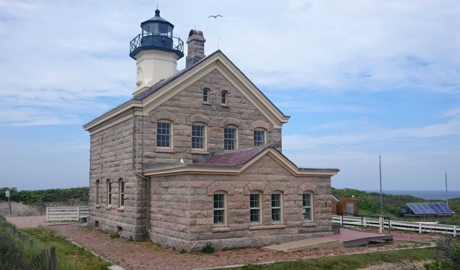 Block Island North Light, a granite lighthouse with a white tower, at Sandy Point on the north end of Block Island