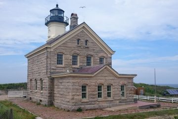 Block Island North Light, a granite lighthouse with a white tower, at Sandy Point on the north end of Block Island