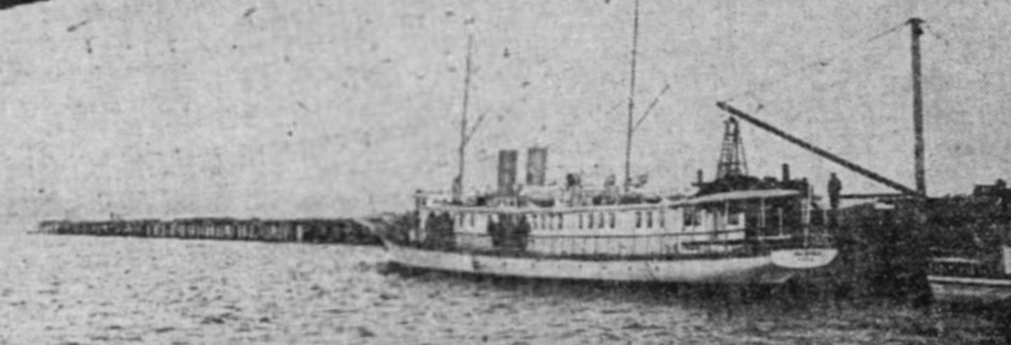 Old photograph of the motor yacht Bayocean tied up at a wooden wharf on Tillamook Bay