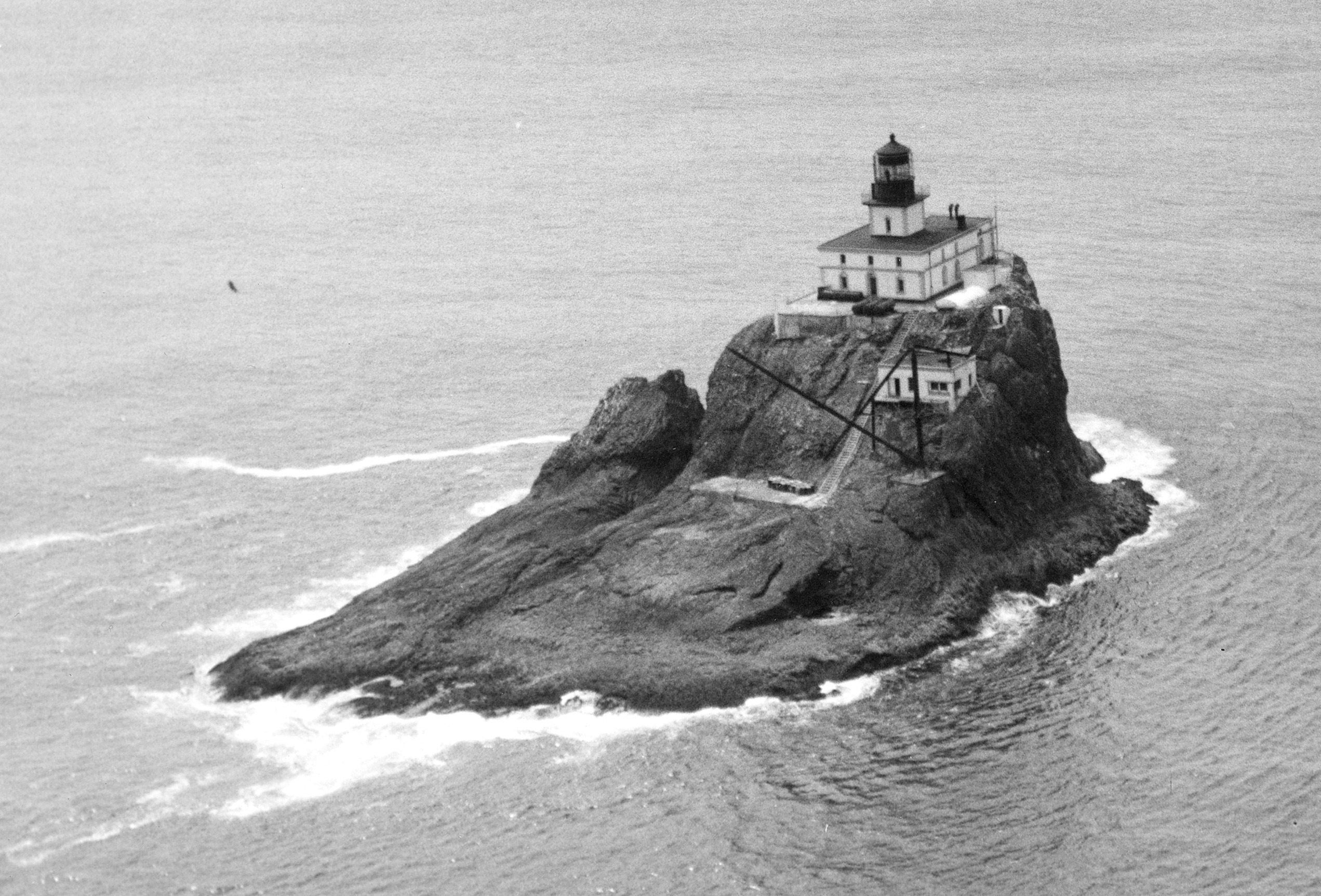 Black-and-white photograph of Tillamook Rock Lighthouse on its steep offshore rock