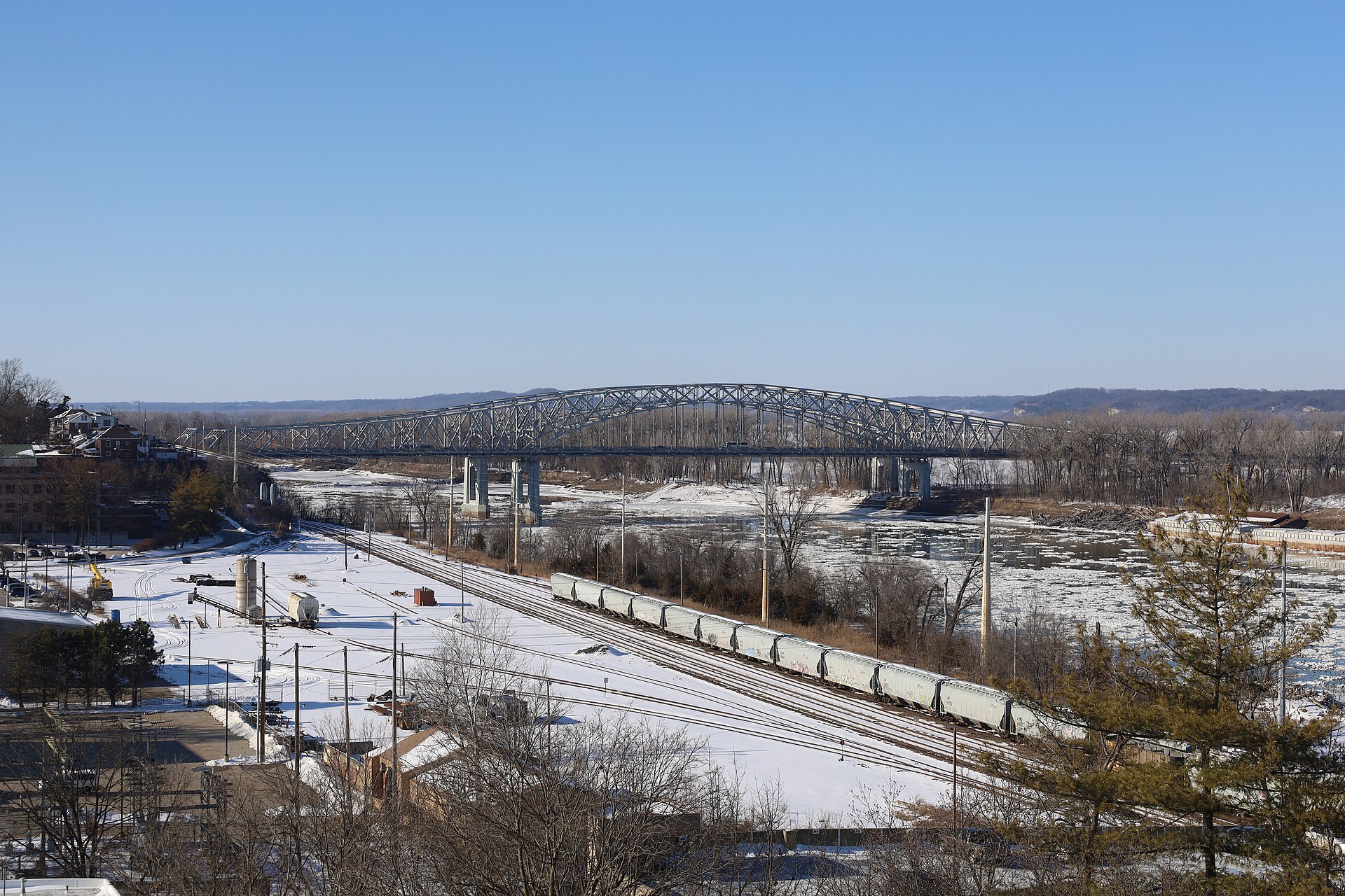 The Missouri River at Jefferson City in winter, with the railroad tracks along the shore and the arched river bridge